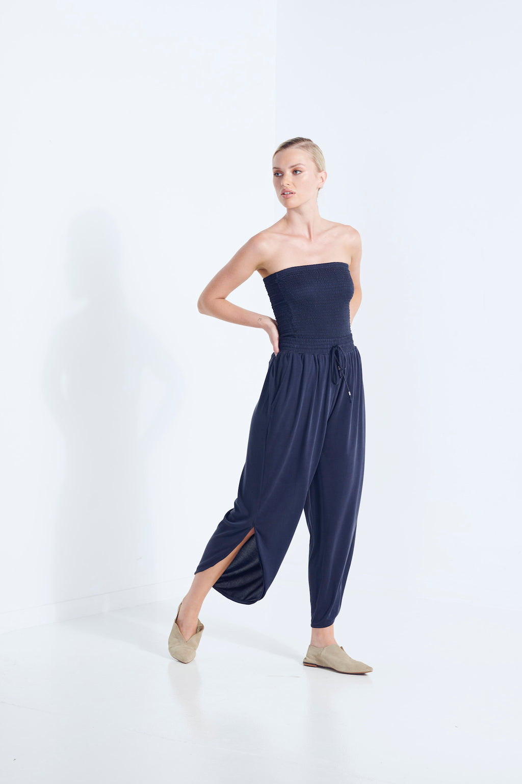 BELU PANT AEGEAN NAVY LUXURY LOUNGEWEAR RELAXED KNIT PANT WITH ELASTIC WAIST AND PETAL HEM  WALKING VIEW