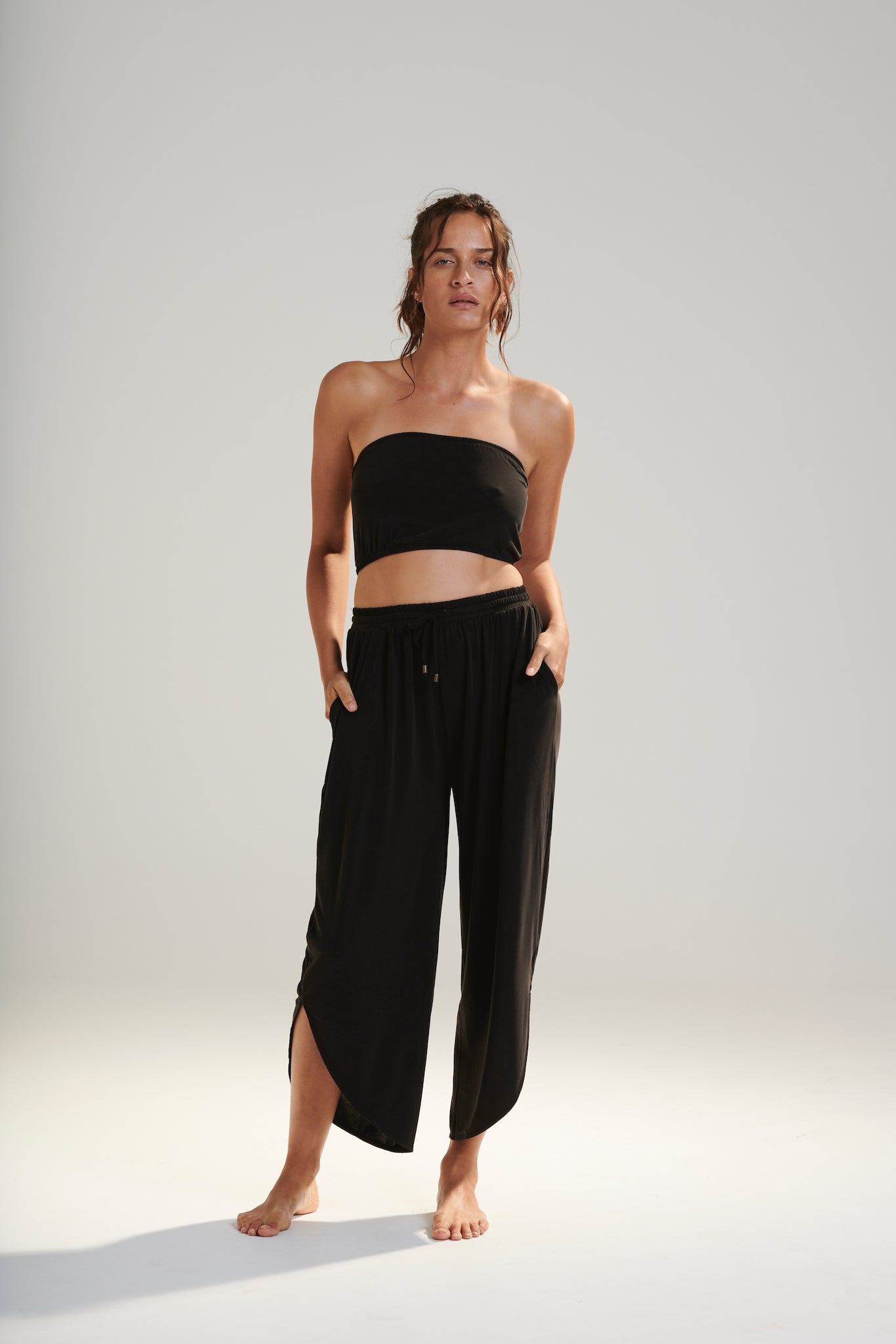 BELU PANT DARK WASHED BLACK LUXURY LOUNGEWEAR RELAXED KNIT PANTS WITH ELASTIC WAIST AND PETAL HEM FRONT VIEW