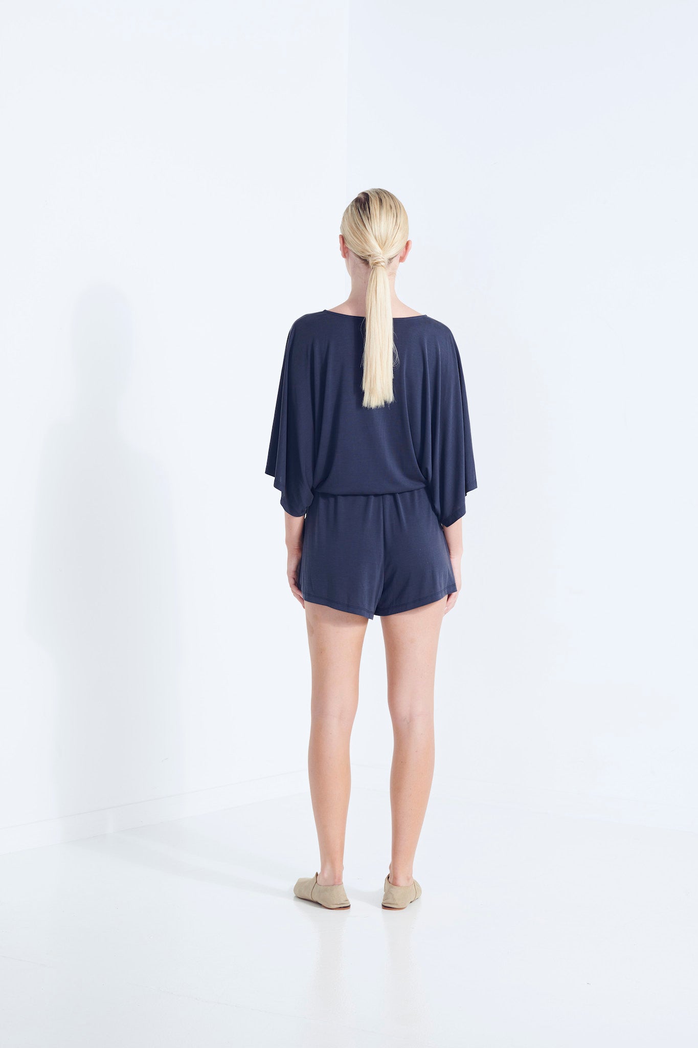 CARRIE PLAYSUIT BEECHWOOD MODAL STRETCH ROMPER  WITH WRAP FRONT TIE WAIST AND POCKETS IN AEGEAN WASHED NAVY  BACK VIEW