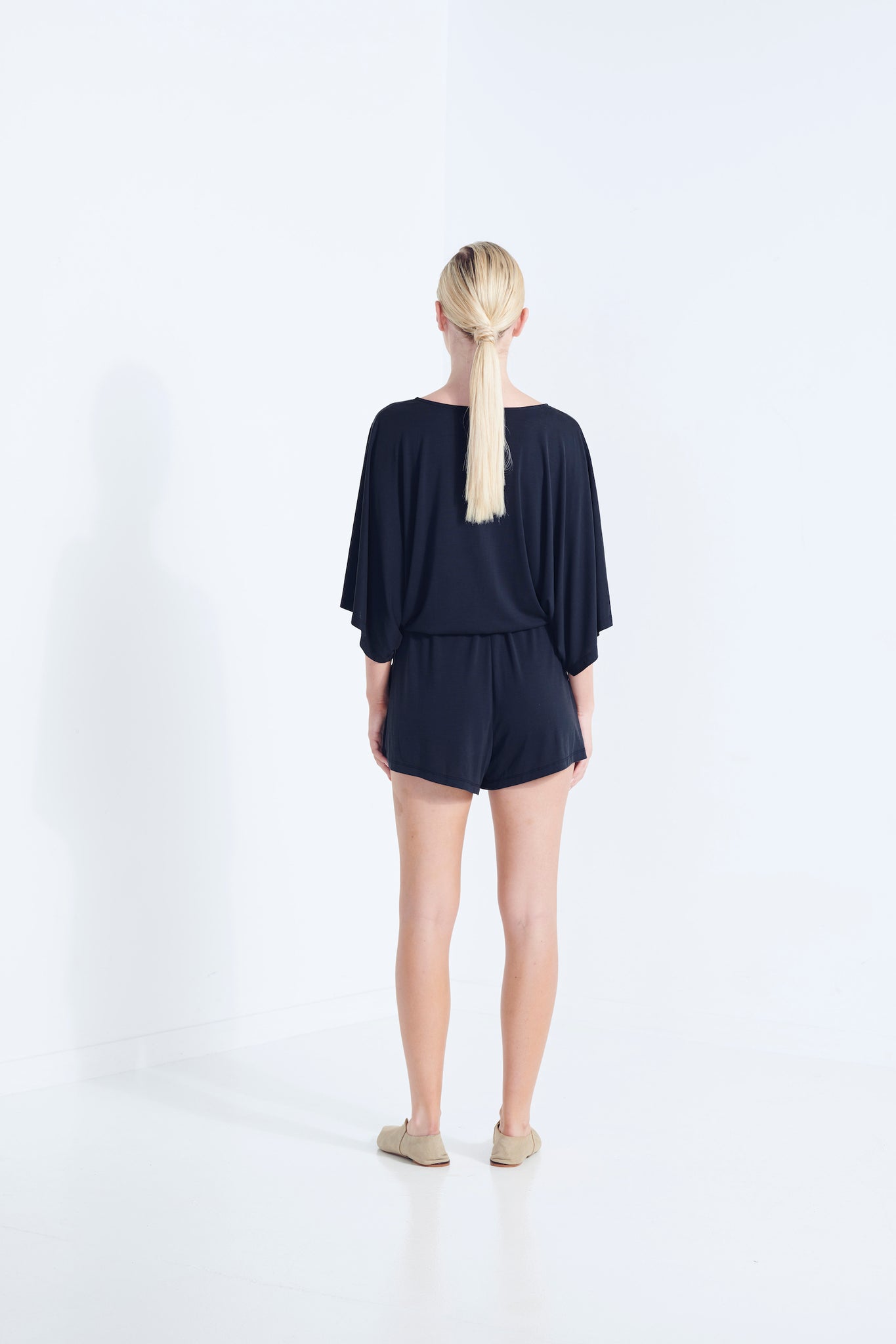 CARRIE PLAYSUIT BEECHWOOD MODAL STRETCH ROMPER  WITH WRAP FRONT TIE WAIST AND POCKETS IN DARK WASHED BLACK BACK VIEW