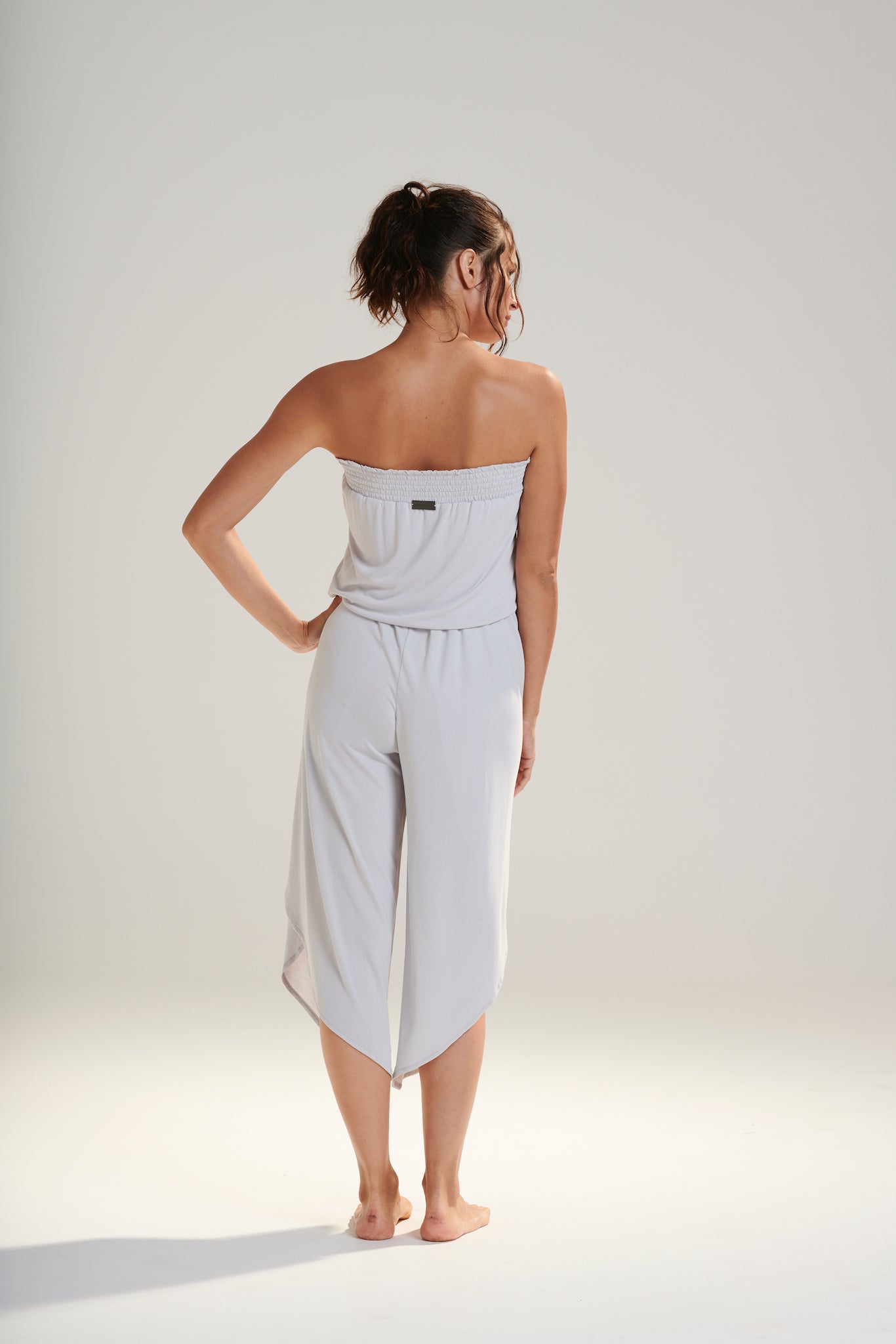 FREYA JUMPSUIT BEECHWOOD MODAL JERSEY SHIRRED BODICE AND PETAL WRAP LEG WITH ELASTIC WAIST AND REMOVABLE TIE IN WISP WASHED PALE GREY BACK VIEW