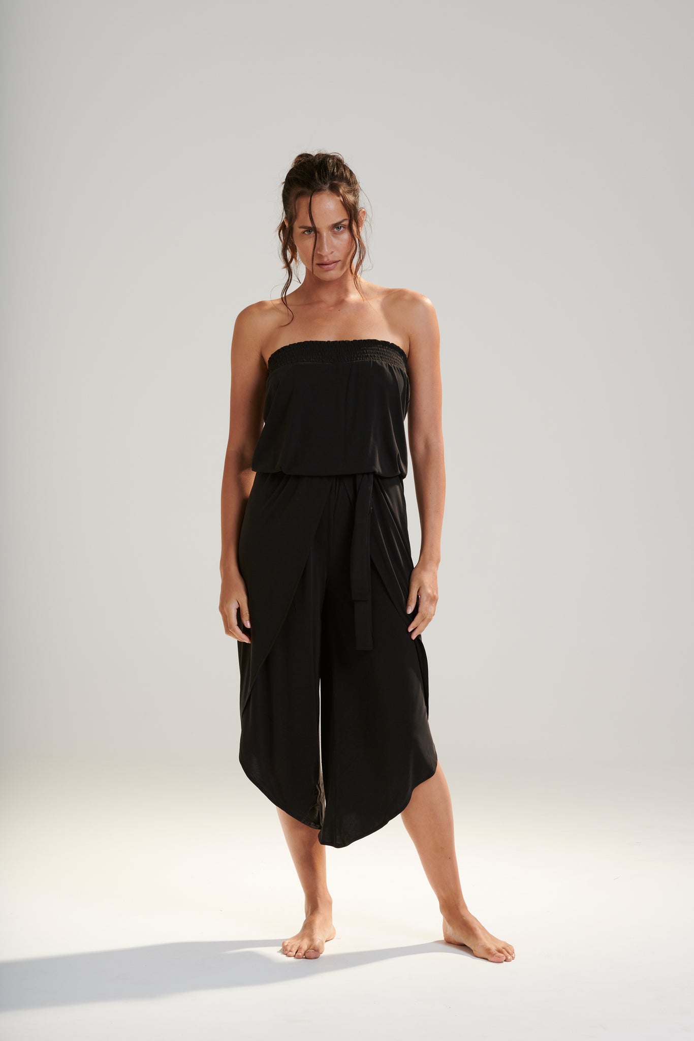 FREYA JUMPSUIT BEECHWOOD MODAL JERSEY SHIRRED BODICE AND PETAL WRAP LEG WITH ELASTIC WAIST AND REMOVABLE TIE IN DARK WASHED BLACK RELAXED FRONT VIEW