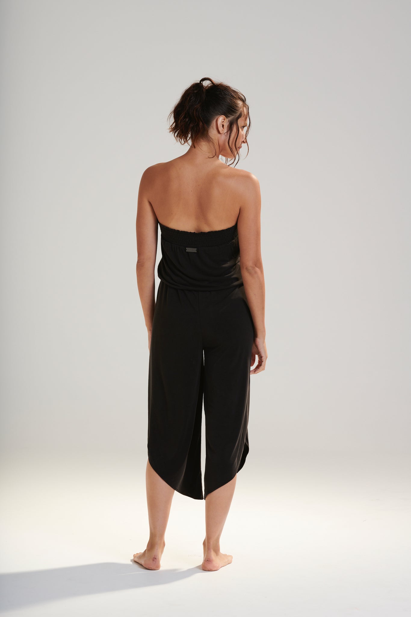 FREYA JUMPSUIT BEECHWOOD MODAL JERSEY SHIRRED BODICE AND PETAL WRAP LEG WITH ELASTIC WAIST AND REMOVABLE TIE IN DARK WASHED BLACK BACK VIEW