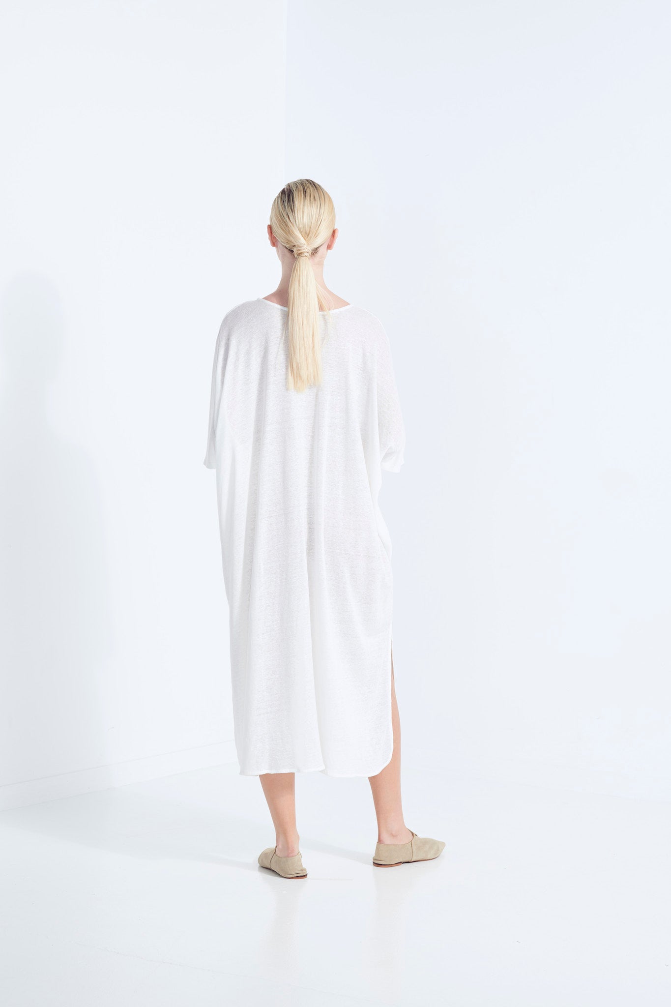 ZEUS DRESS PURE LINEN NATURAL YARN IN A MILKY ICE WHITE WITH SIDE HEM SCOOP AND SELF FABRIC TIE  BACK VIEW